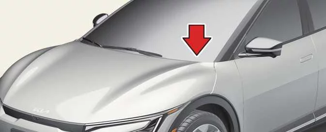Dashboard VIN label visible through the windshield of the Kia EV6