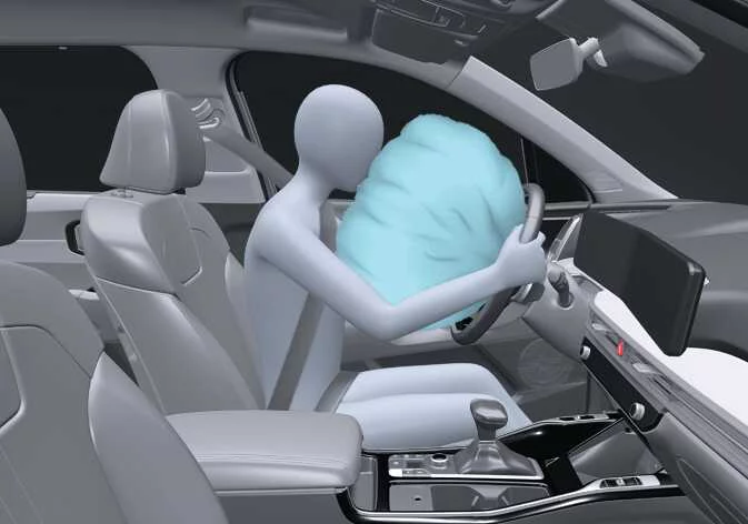 Illustration of the tear seams in the Kia K4 steering wheel pad cover separating during airbag deployment