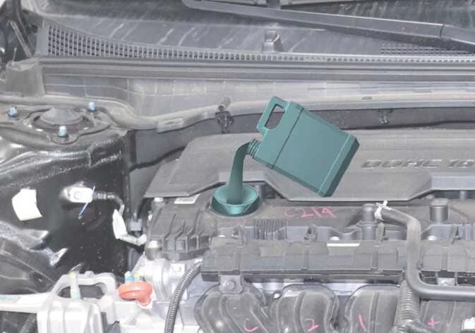 Close-up view of the dipstick F-L oil level markings on a Kia K4 engine