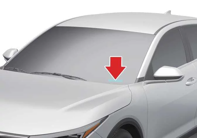 Kia K4 dashboard metal plate displaying the unique 17-character Vehicle Identification Number visible through the lower driver-side corner of the front windshield