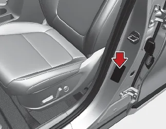 Kia Seltos tire specification and tire pressure label on driver side center pillar